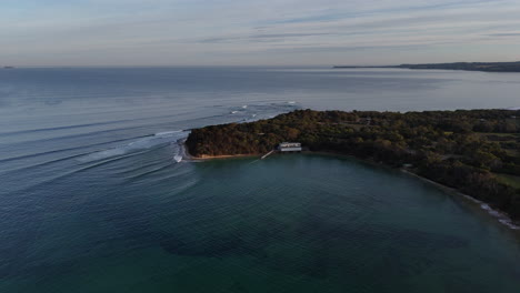 beautiful calm waters reflect the serene sky, with sailing enthusiasts enjoying a tranquil atmosphere at point leo. the scenery captures the essence of outdoor recreation and relaxation.