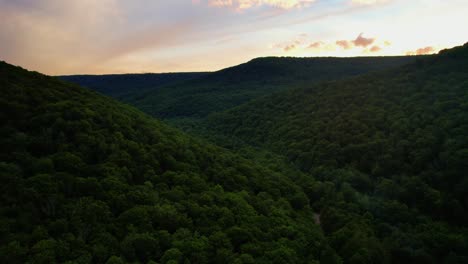 stunning drone video footage of a stunning appalachian mountain valley during summer at sunset with beautiful golden light