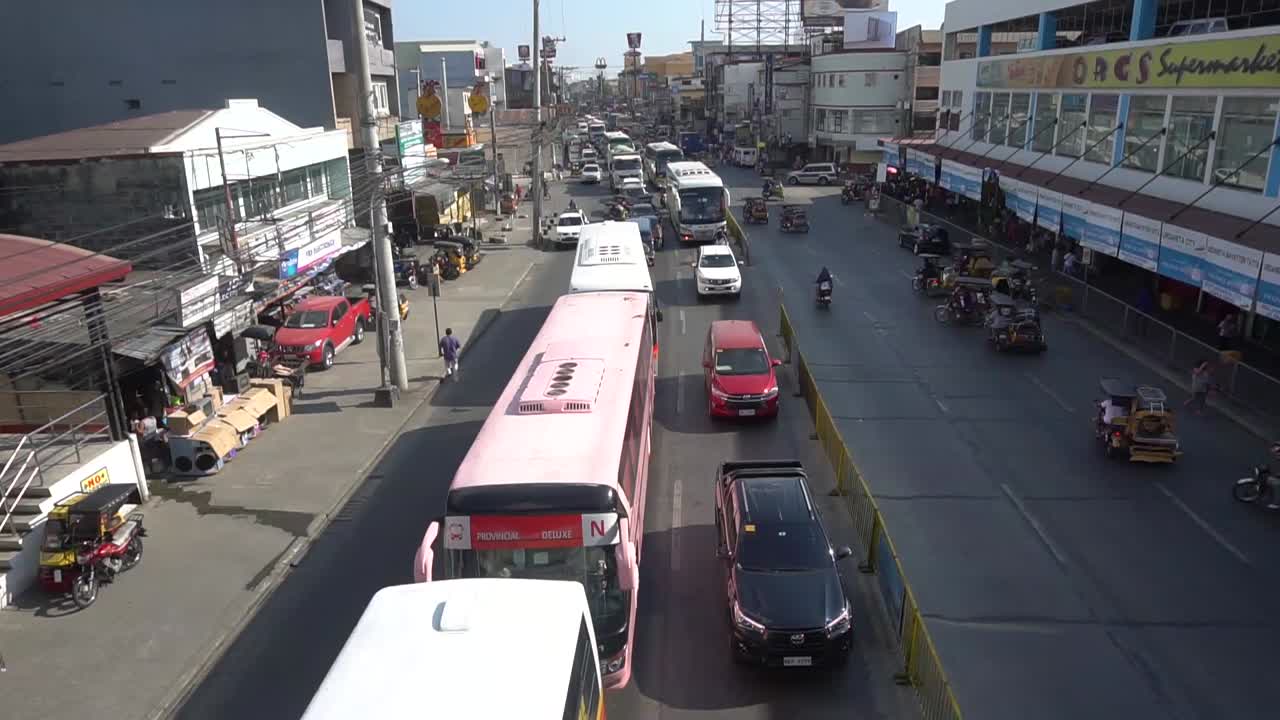 Stabilized cinematic shot from a bridge of vehicle traffic