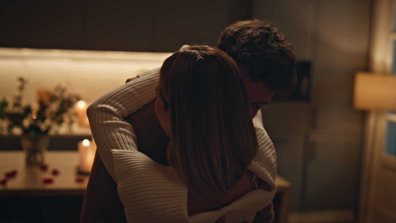 Sensual pair dancing night date in cozy candles atmosphere hugging close up.