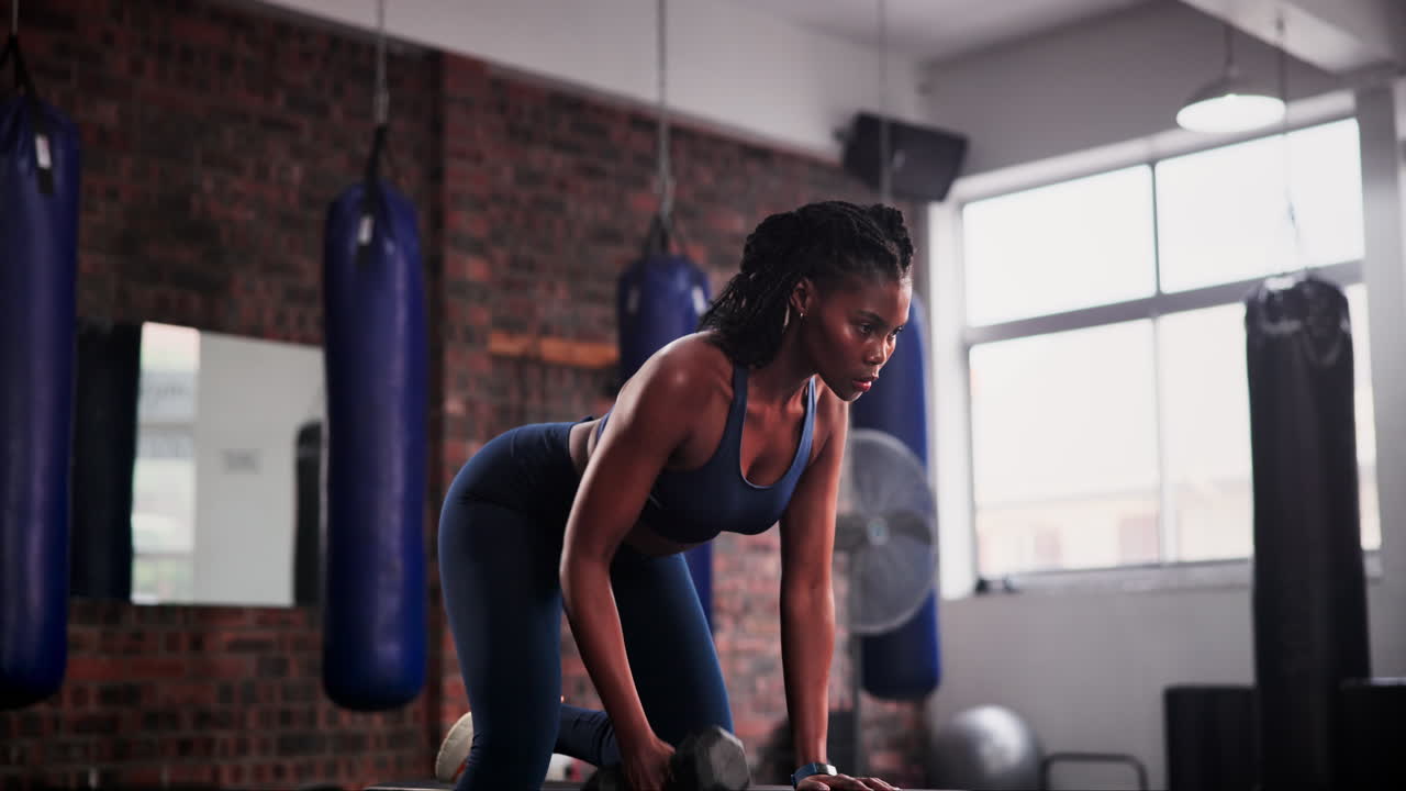 Woman working out with dumbbells in a gym