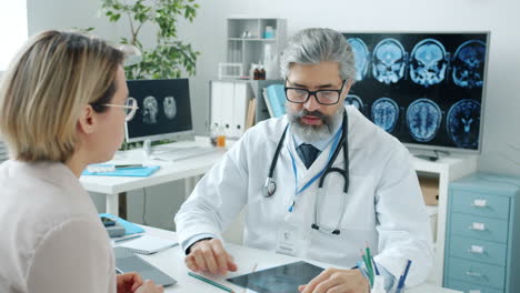 el médico discutiendo imágenes médicas con el paciente