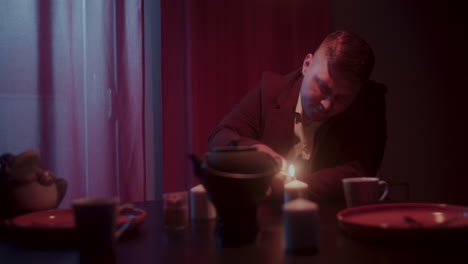 man enjoying a warm drink at night