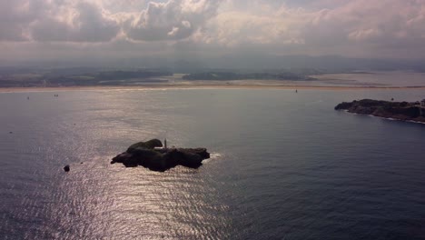 aerial view of santander city in spain cantabria region, harbor and lighthouse on the small island during cloudy sunset