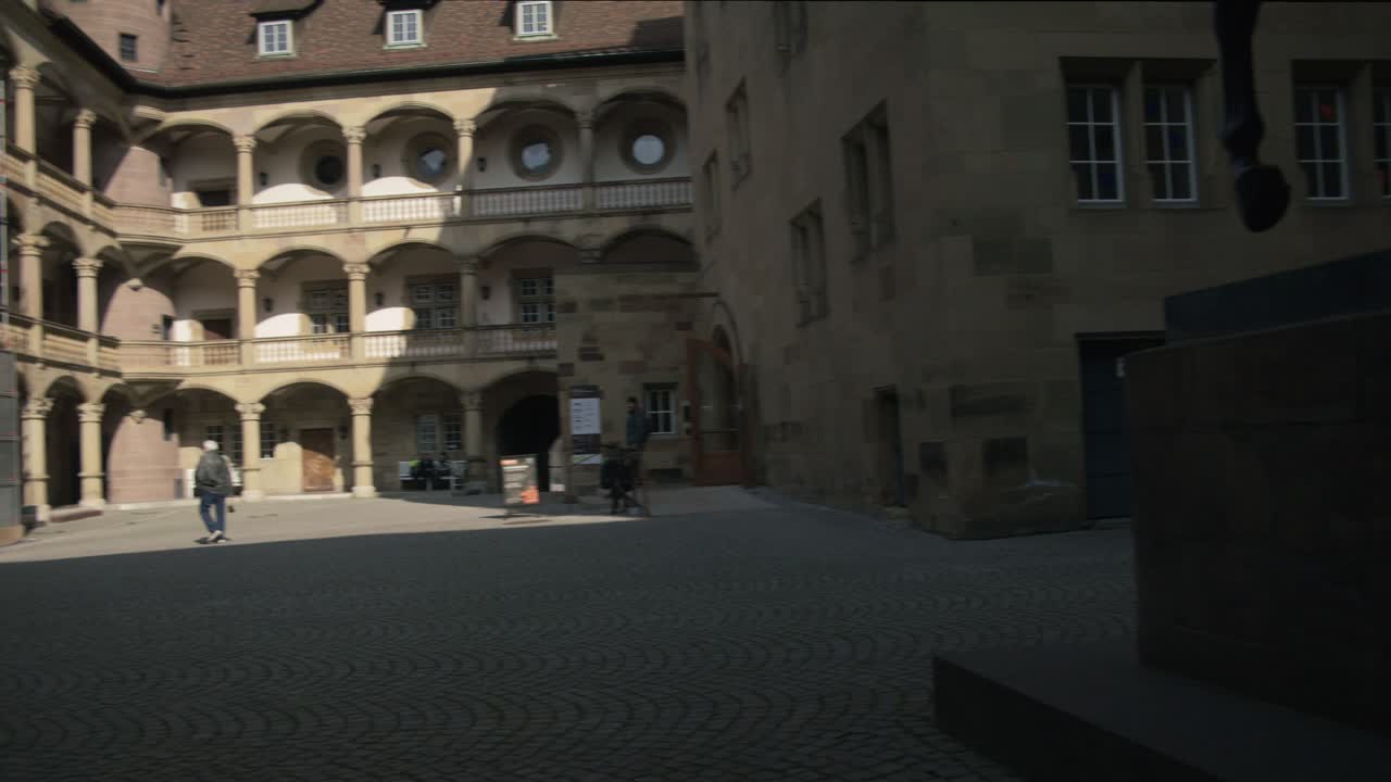 Vecchia statua vicino a un edificio museale a più livelli - Schlossplatz nel centro di Stoccarda in 4K, architettura classica tedesca, famosa, lente Red Komodo Cooke Mini S4i di qualità premium | Notizie.