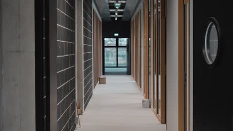 dolly shot through an office corridor with private work rooms to each side