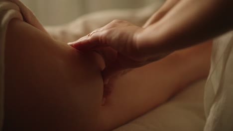 Professional-leg-massage-in-dimly-lit-room