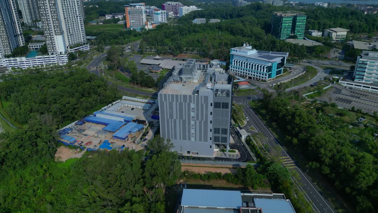 Tòa nhà trung tâm dữ liệu hiện đại nằm giữa không gian xanh, đại diện cho cơ sở hạ tầng công nghệ mạng lưới toàn cầu, dữ liệu lớn và điện toán đám mây. Cảnh quay drone tuyệt đẹp từ trên cao.