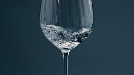 clear water filling cup closeup. pure refreshing beverage pour into transparent