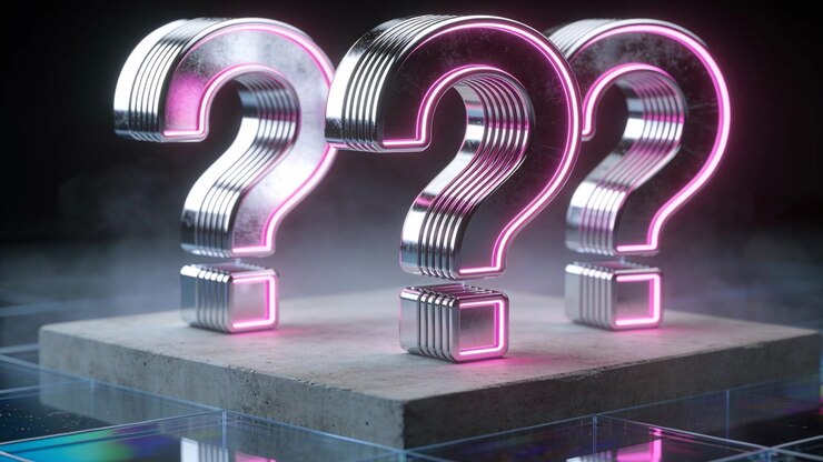 Dollying camera focusing on three metal question marks on studio pedestal, showing neon pink glow