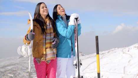 two young woman with their snowboards