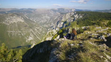 young woman is admiring tara canyon from curevac viewpoint in durmitor national park in montenegro