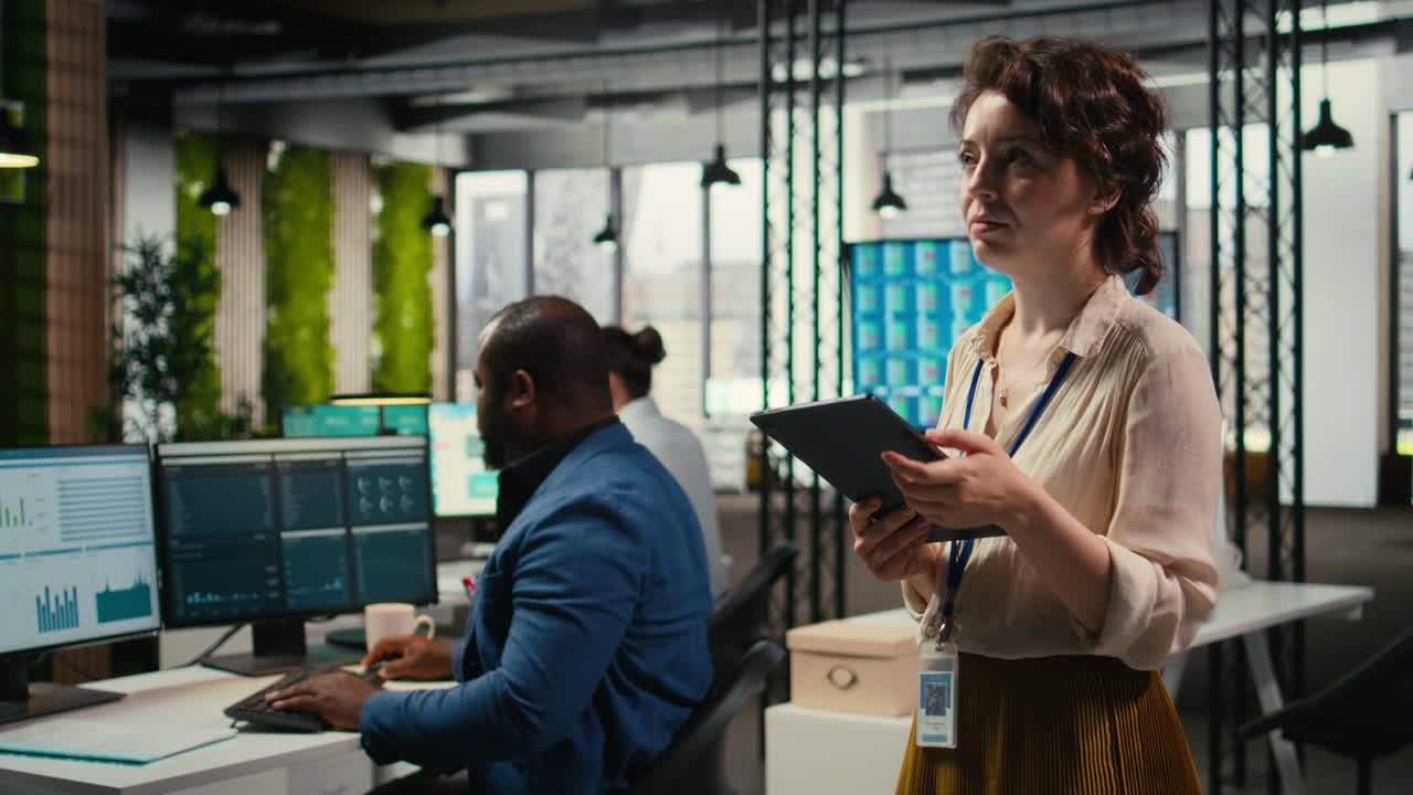 Vertical Video Pensive woman business leader does forecasting on her tablet in the office