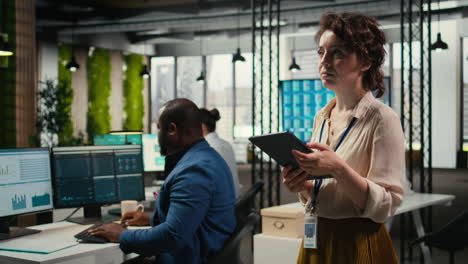 vertical video pensive woman business leader does forecasting on her tablet in the office