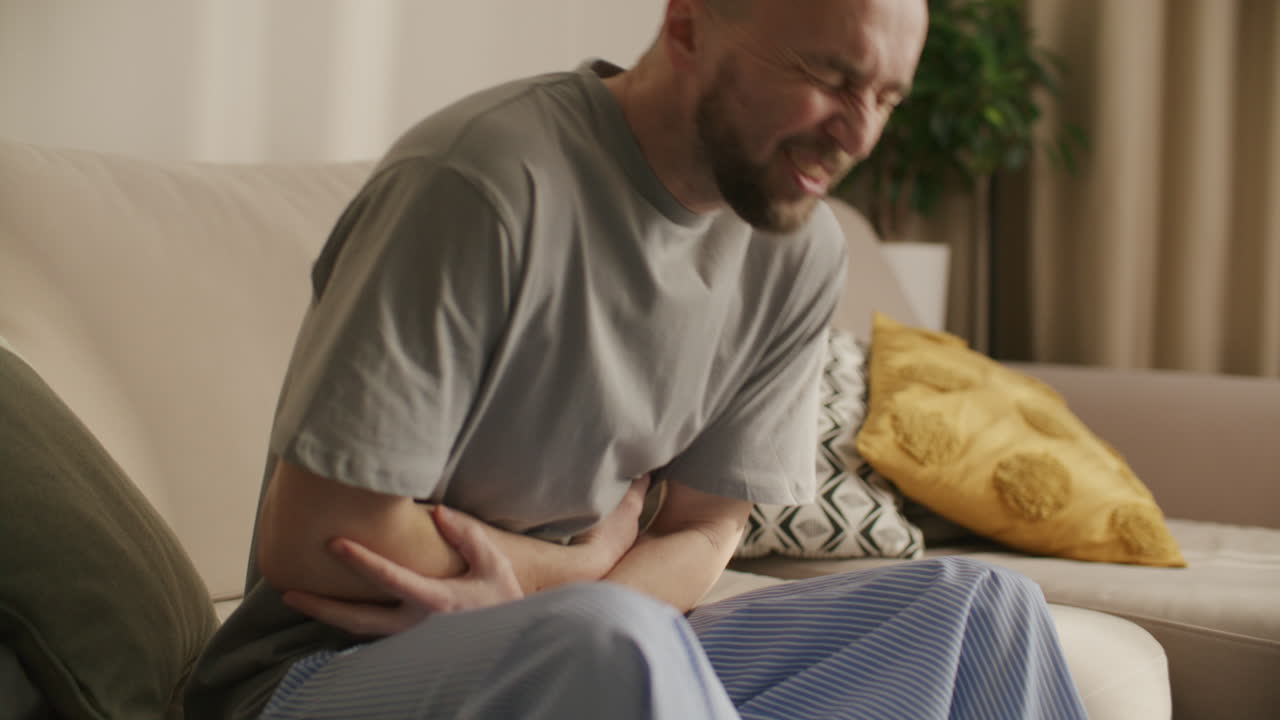 Man Suffering from Severe Stomach Pain at Home