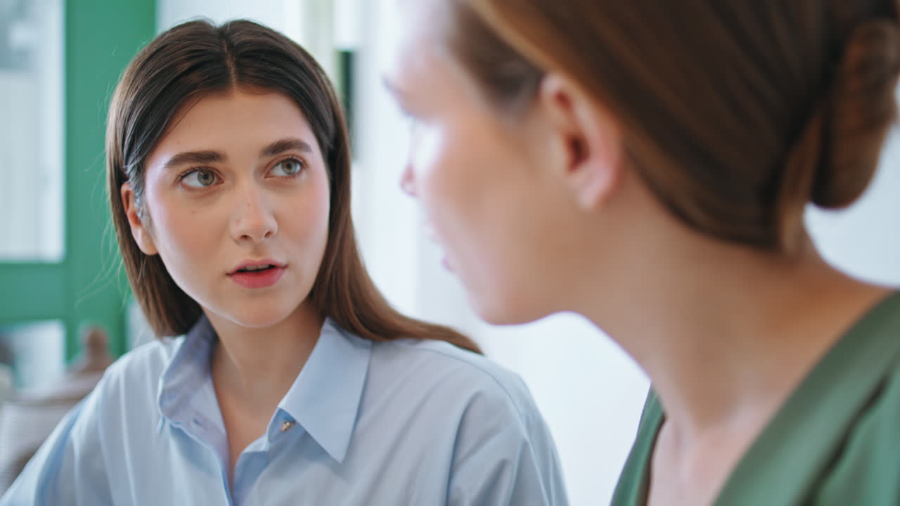 Two employees working project together closeup. Worried woman talking smartphone