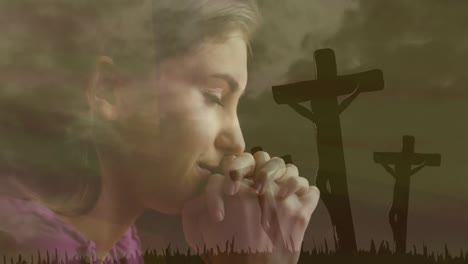 Animation-of-religious-woman-praying-and-meditating-over-silhouettes-of-three-Christian-crosses-