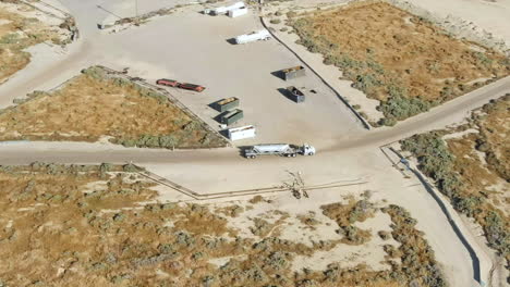 oil tanker driving in to an oil refinery - aerial orbiting follow parallax