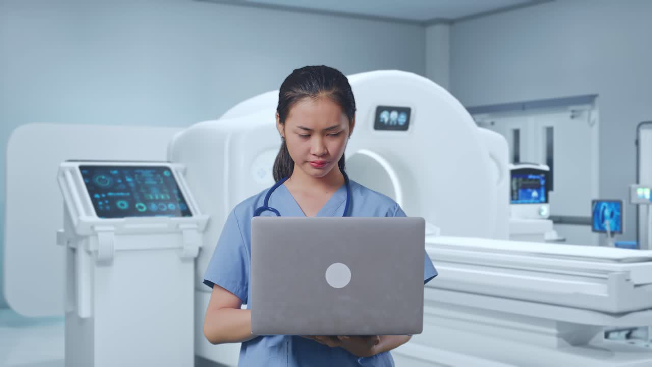 Asian Female Doctor Having A Serious While Working On A Laptop With Mri Machine