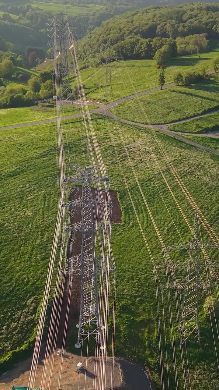 Aerial View of Electricity Pylon and Power Lines in Green Rural Landscape