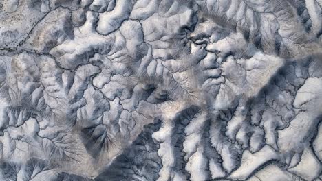 Inhospitable-grey-mountain-area,-foreign-planet-with-many-dried-river-veins