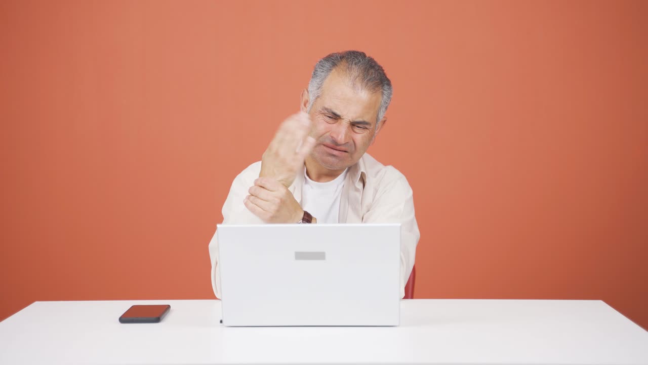 la muñeca del hombre que usa una computadora portátil duele.