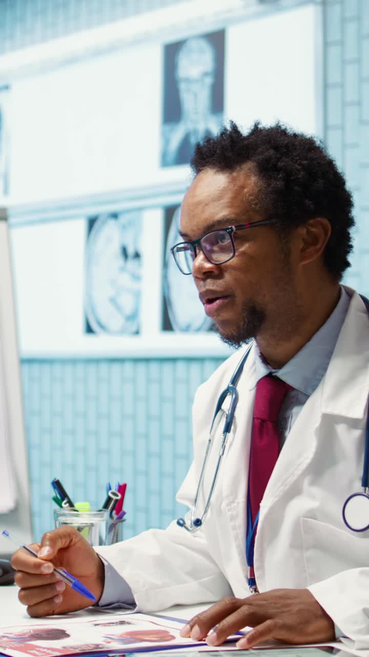 African American Doctor Consulting and Reviewing Medical Charts in Office