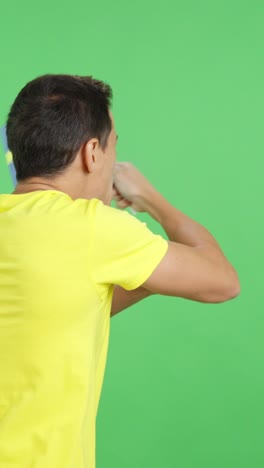 rear view of a man waving a swedish pennant