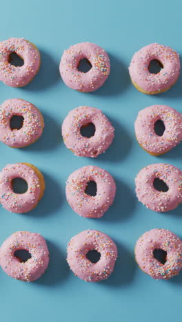 video of donuts with icing on blue background