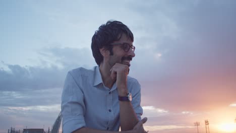 man contemplating at sunset