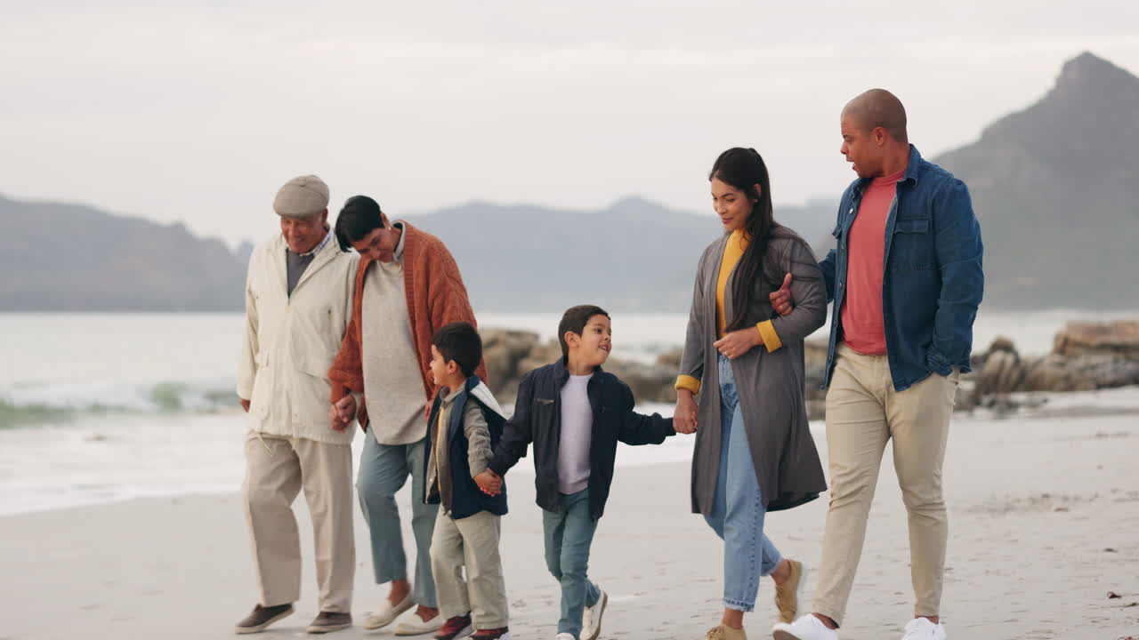 Family, walking on beach and holding hands