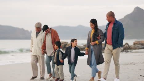 family, walking on beach and holding hands