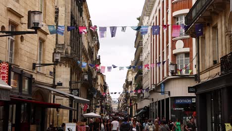 crowded street scene with people and shops