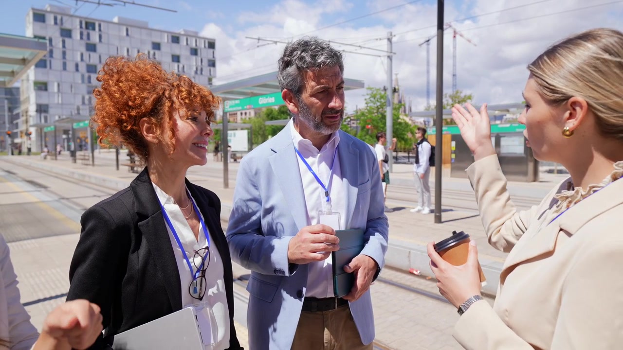 Business Professionals Discussing Outdoors at a Tram Stop