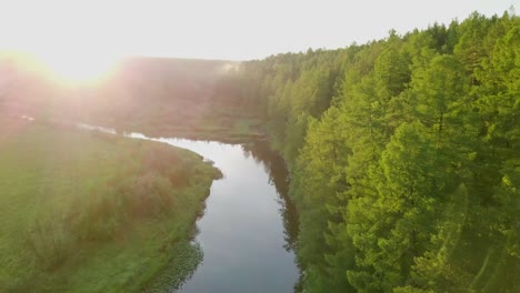 sunrise over a serene river and forest