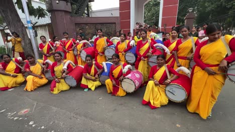 women dhol drummers in traditional indian attire performing