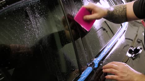 man covering car with vinyl polyurethane tape. films for the car. sticker protective film on the car