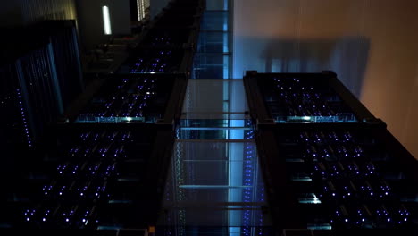 rows of server racks with glowing blue lights in a modern data center