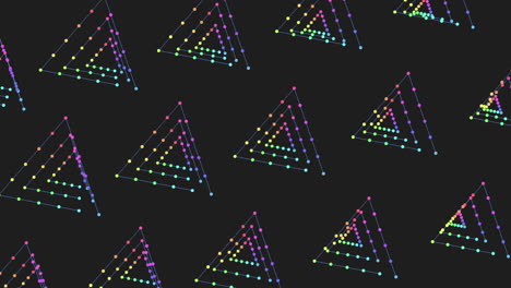 an artistic arrangement of colorful dots forming a triangular shape on a black background, with shades of purple, blue, and green creating an appealing pattern
