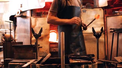 glassblower shaping a molten glass