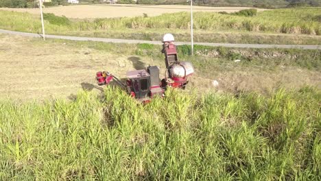 Closeup-of-sugar-cane-harvester-as-it-moves-through-field