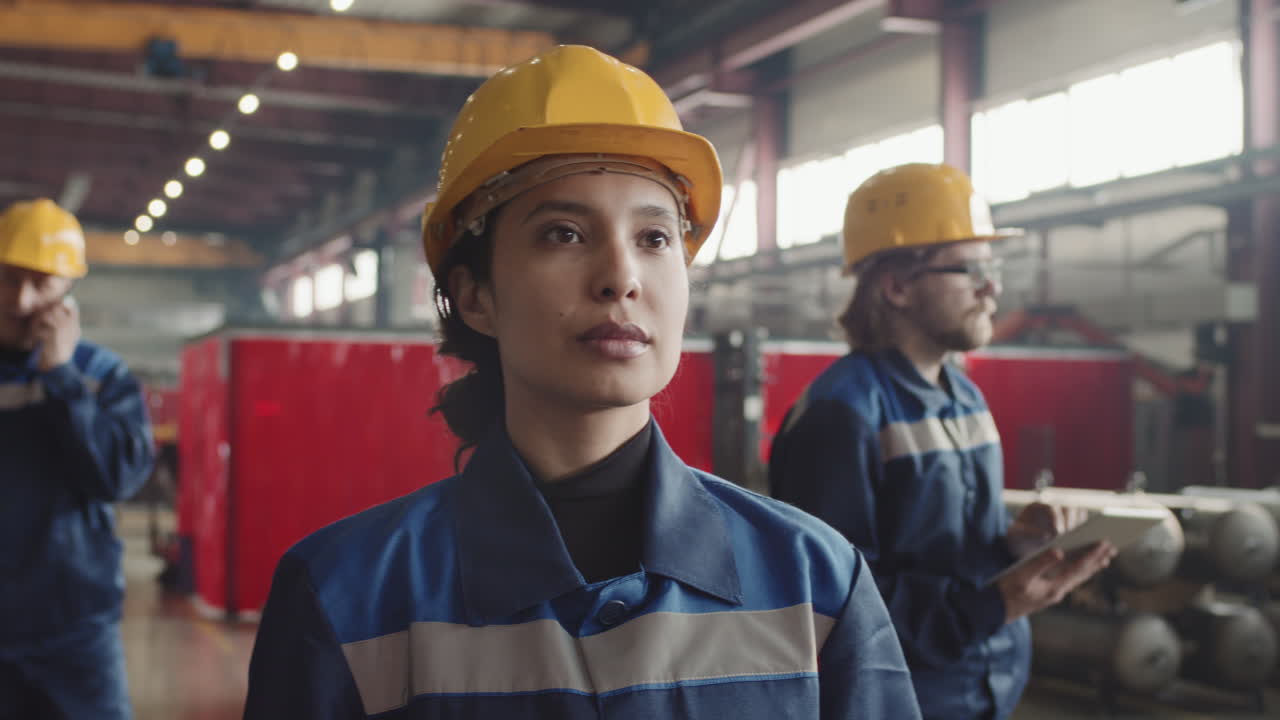 Confident Female Supervisor Walking Through Plant Facility