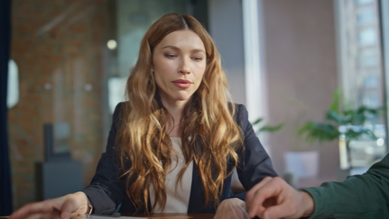 Woman designer presenting project to attentive man in modern office closeup