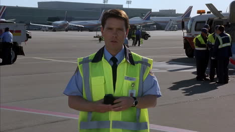 airport ground crew member using walkie-talkie
