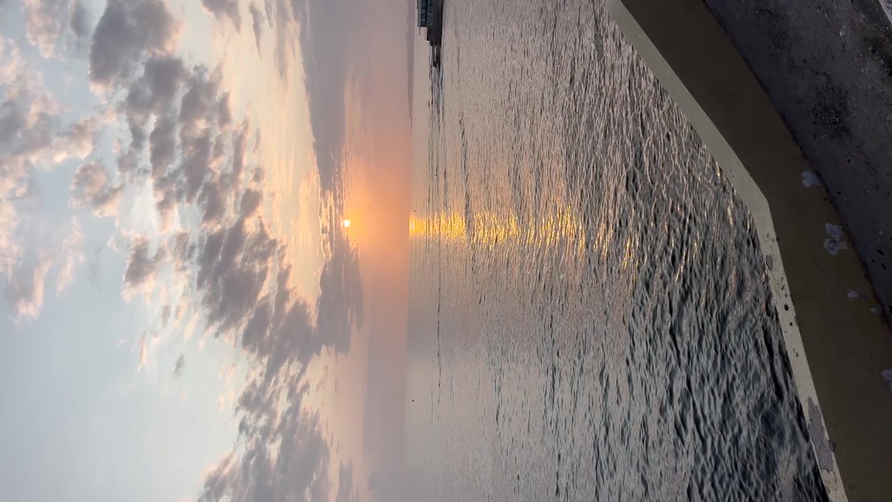 Sunset on the beach Atlantic Ocean calm water vertical video calm romantic coast Portugal