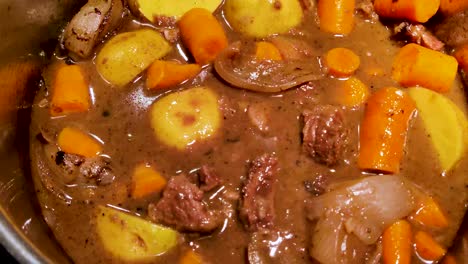 making the best red wine beef stew including chuck roast, red wine, potatoes, and carrots