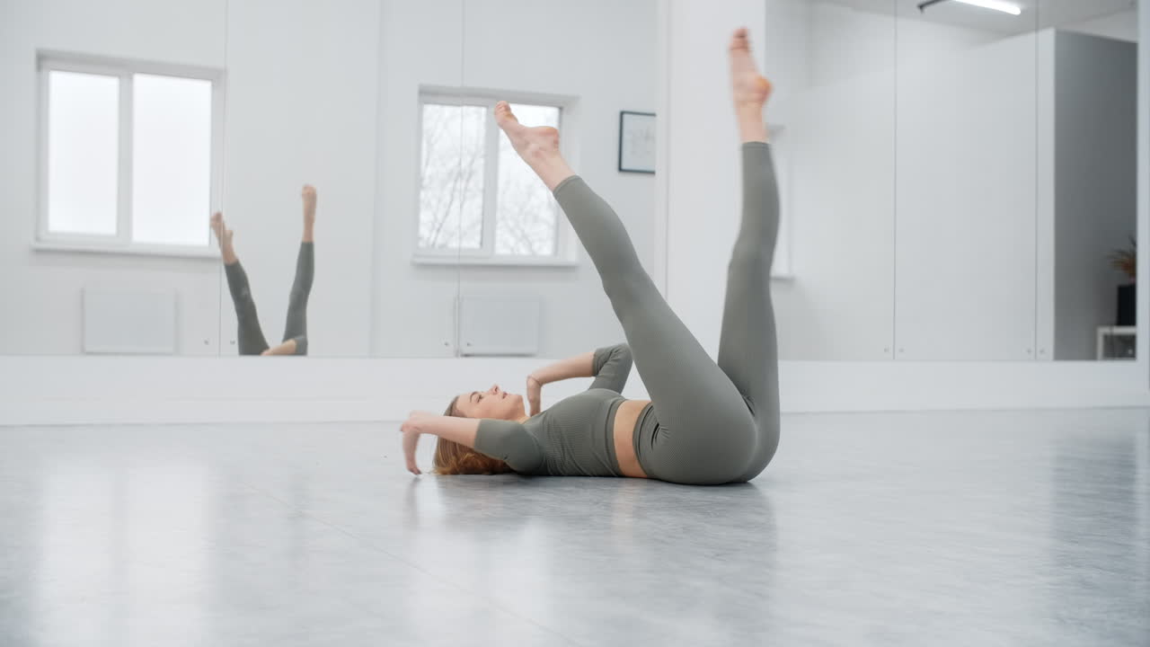Woman stretching and dancing in a dance studio