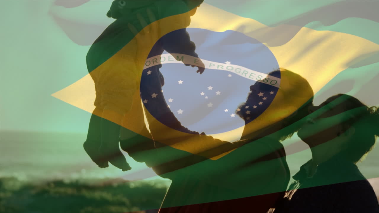Animation of waving brazil flag against caucasian couple holding their baby at the beach