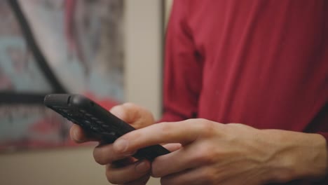 Close-up-Of-Male-Hands-Using-Smartphone-Indoors