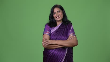 mature happy beautiful indian woman with arms crossed wearing sari traditional clothes